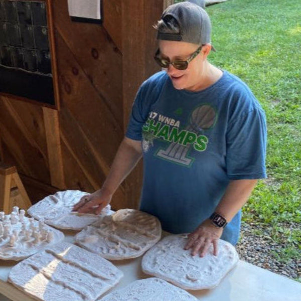 Cheri Owen exploring tactile ceramic art with her hands