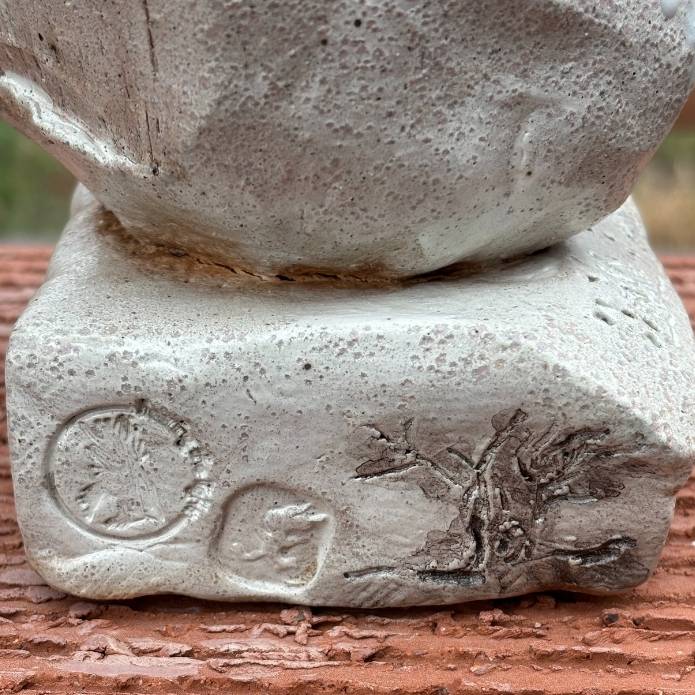 Close up of tree details of Cheri Owen’s ceramic sculpture titled “You Are Safe Totem,” featuring textured glaze and Braille message “You Are Safe”