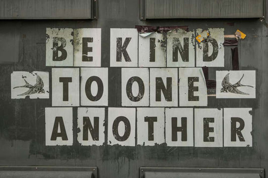 brown image with words "be kind to one another" on it