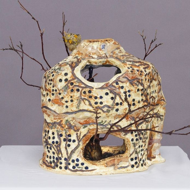 Ceramic Vase with holes, dots and branches with earthy tones. 
