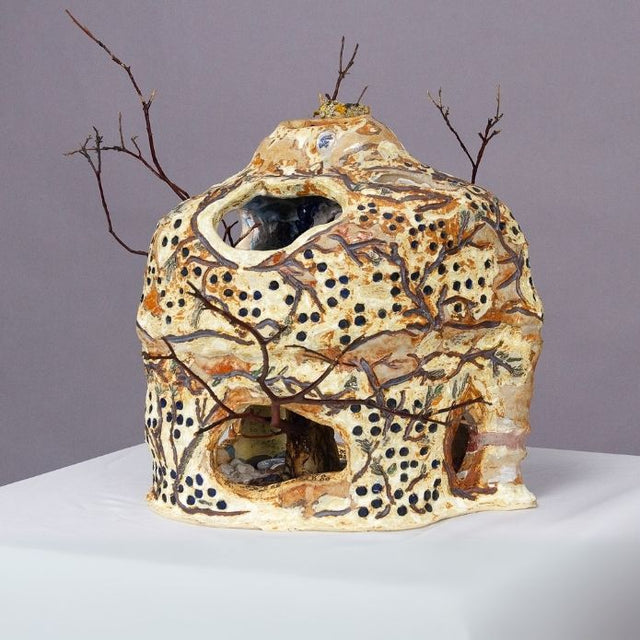 Ceramic Vase with holes, dots and branches with earthy tones. 
