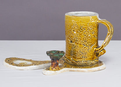 Saucer and Mug textured yellow ceramic set with abstract shapes with a small green tree.