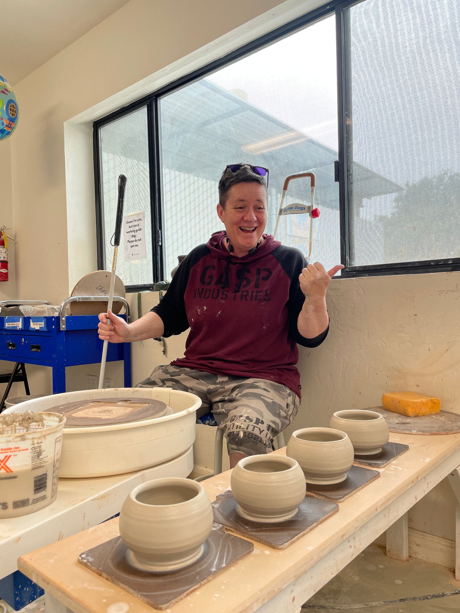 Cheri Owen sitting with clay bowls