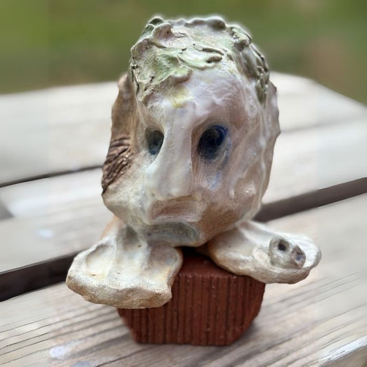 Front view of Cheri Owen’s ceramic sculpture titled “Nope,” featuring textured glaze and Braille message “You Are Safe”
