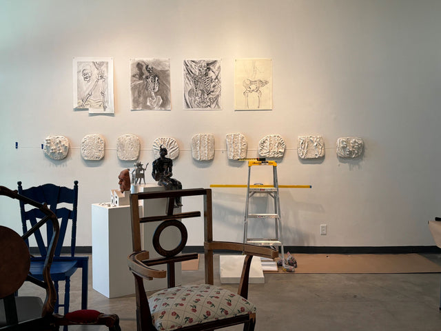 Picture of Studio with art work on wall and sculptures on table