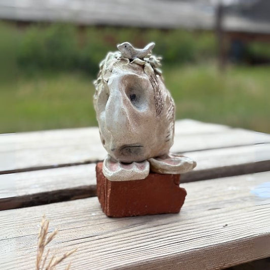 Ceramic sculpture by Cheri Owen featuring Braille that reads “You Are Safe,” with layered glaze and organic, hand-sculpted form.