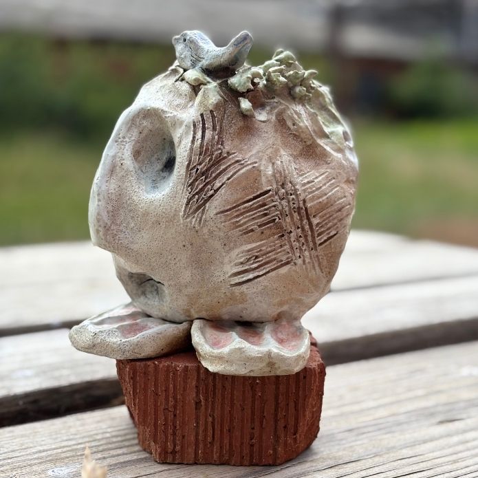 Side view of “You Are Safe” sculpture showing birth, scars and earthy tones, part of Cheri Owen’s tactile art series.