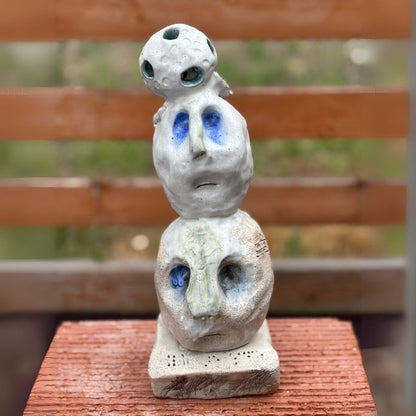 Front view of Cheri Owen’s ceramic sculpture titled “You Are Safe Totem,” featuring textured glaze and Braille message “You Are Safe”
