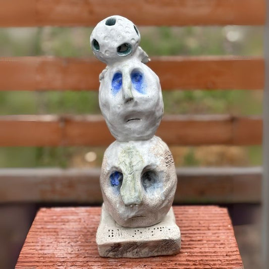 Front view of Cheri Owen’s ceramic sculpture titled “You Are Safe Totem,” featuring textured glaze and Braille message “You Are Safe”