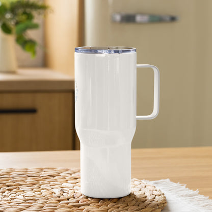 White insulated travel mug with handle on a woven mat in a kitchen setting