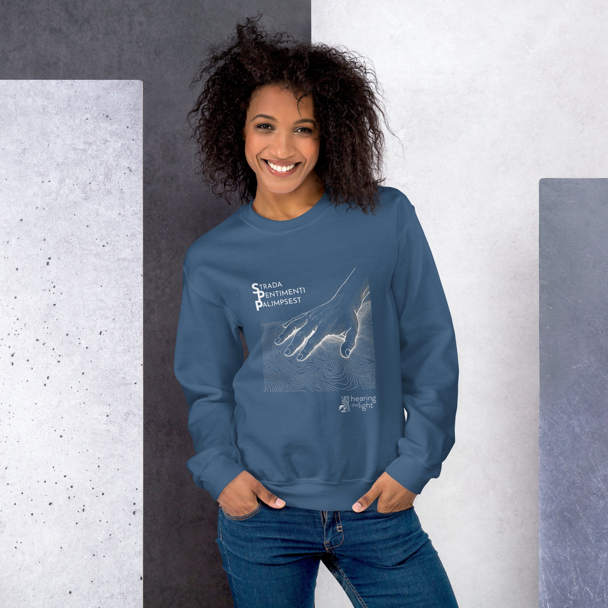 A female wearing an indigo blue sweatshirt with line art and text that reads 'Strada Sentimenti Palimpsest' on a white background