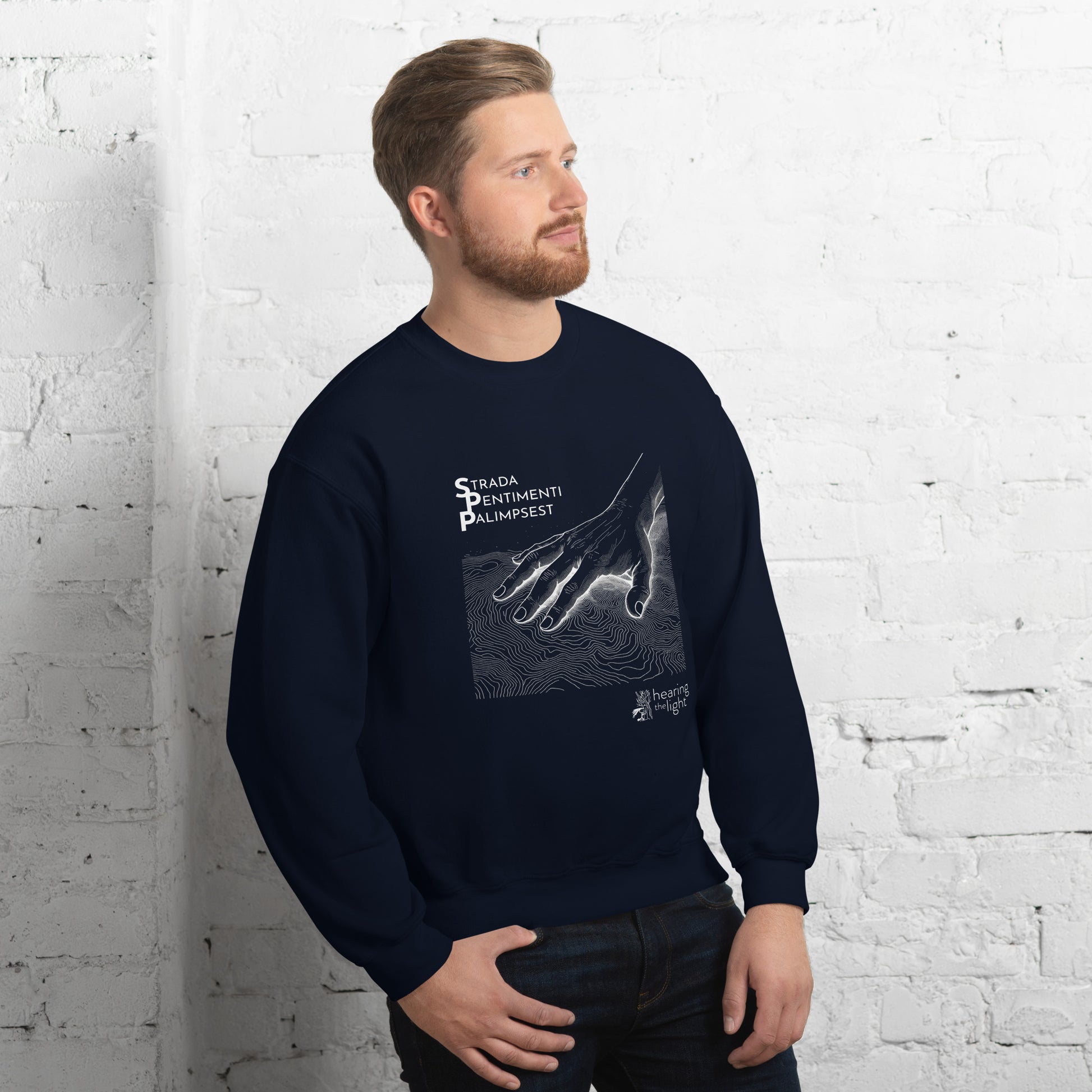 A male wearing a navy sweatshirt with line art and text that reads 'Strada Sentimenti Palimpsest' on a white background